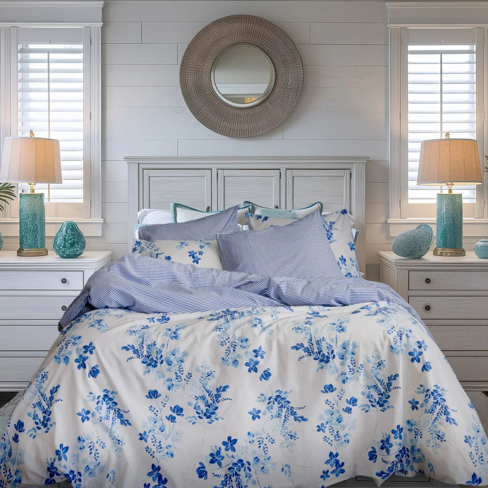 Blue floral duvet cover set on a bed in a bright bedroom with coastal decor